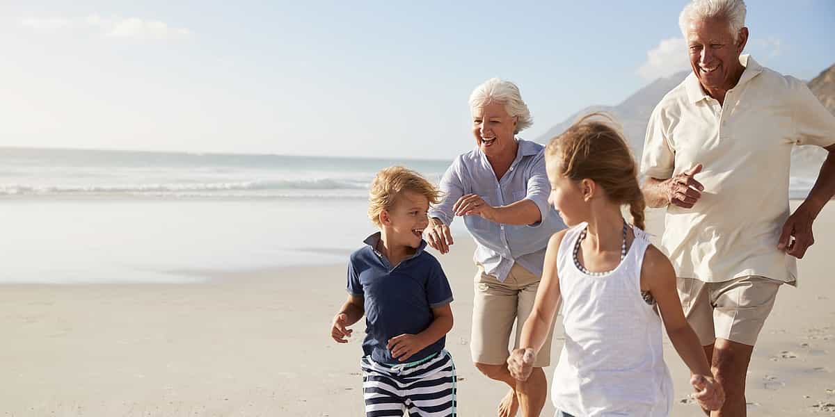 A senior couple chasing their grandkids thinking about who to appoint as their Estate Trustee