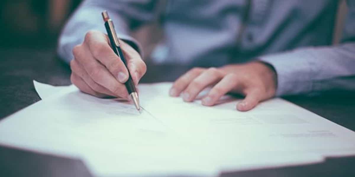 An Executor signing a document after receiving legal Executor advice